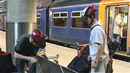 Loading our bagged bikes onto the luggage trolleys at Stansted Airport station